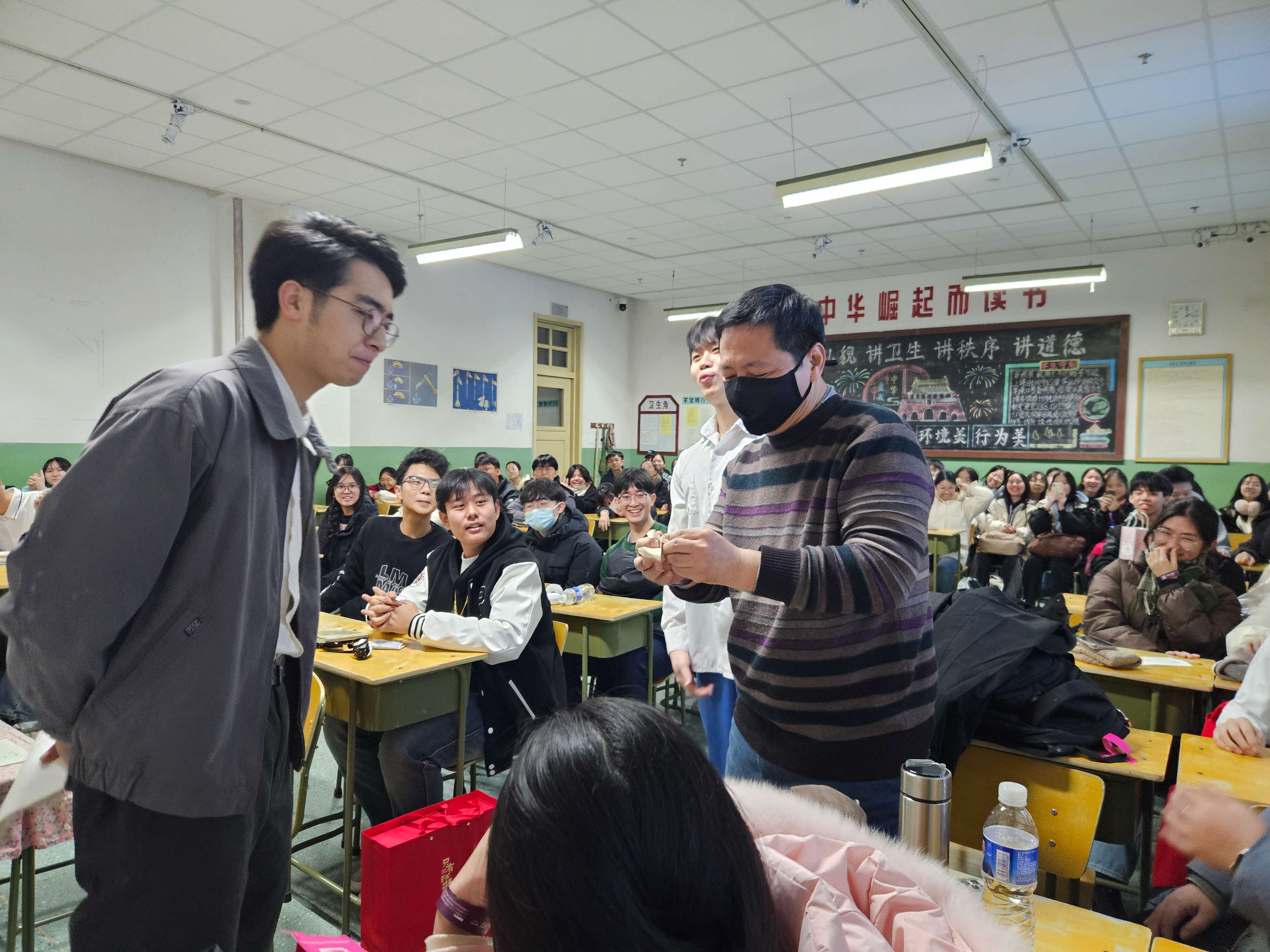 A group of students and teachers participating in an immersive drama experience in Beijing.